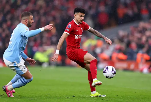 Luis Diaz of Liverpool (R) controls the ball ahead of Kyle Walker