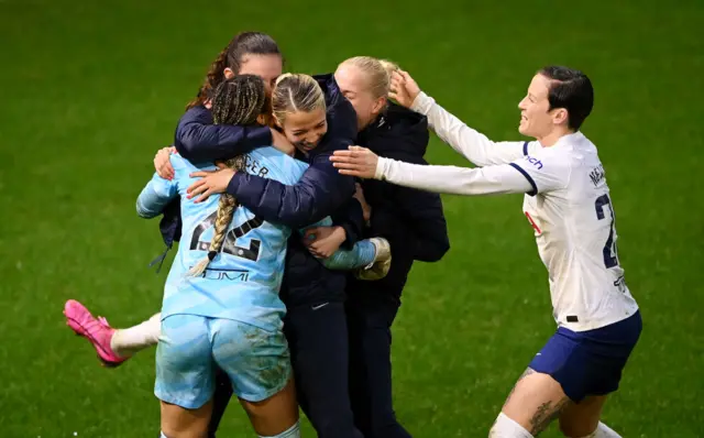 Spurs players congratulate Spencer after her penalty heroics.