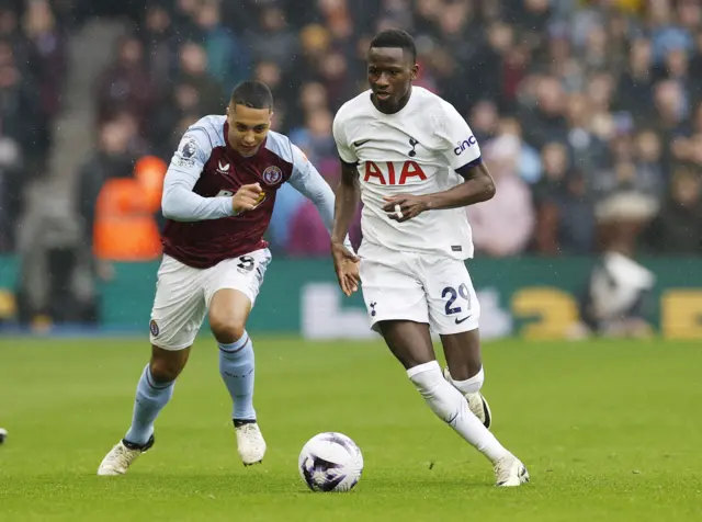 Youri Tielemans in action with Tottenham Hotspur's Pape Matar Sarr