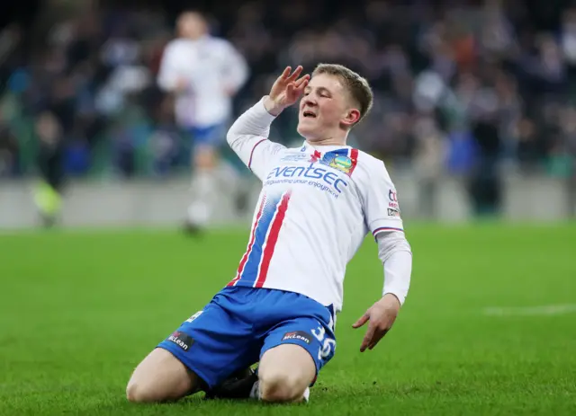 Rhys Annett salutes the Linfield faithful after scoring the Blues' last goal in the 3-1 BetMcLean Cup final win over battling Portadown