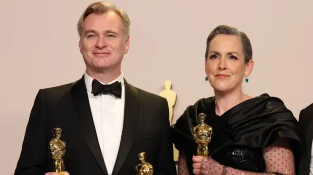 Nolan and Thomas pose with their Oscars