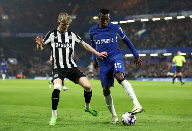 Nicolas Jackson of Chelsea holds the ball whilst under pressure from Anthony Gordon