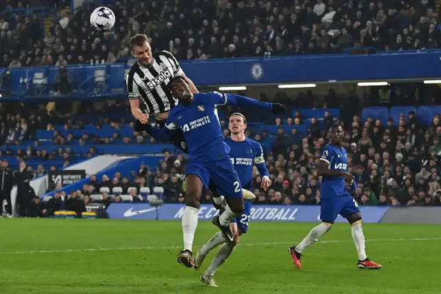 Dan Burn climbs to win a header from Axel Disasi