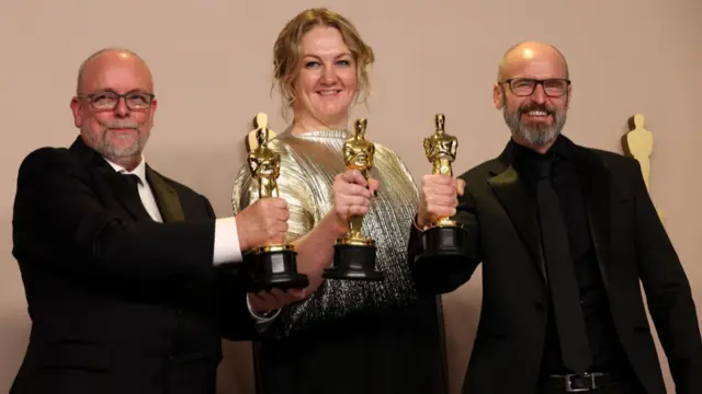 Coulier, Stacey, and Weston smile with their awards