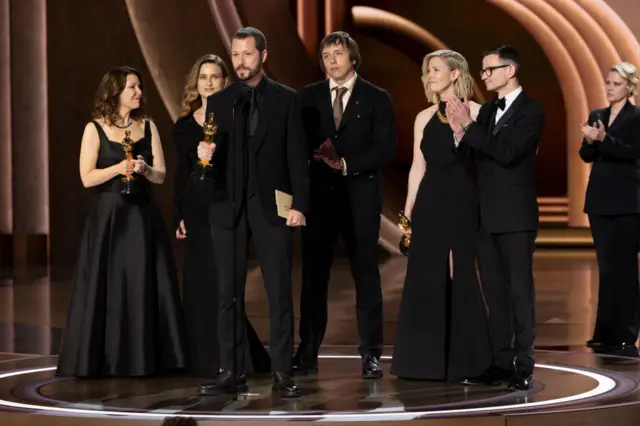 Mstyslav Chernov and team on stage at the Oscars