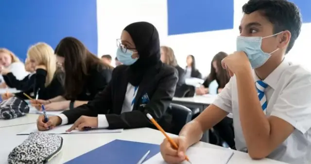 pupils in a classroom wearing masks