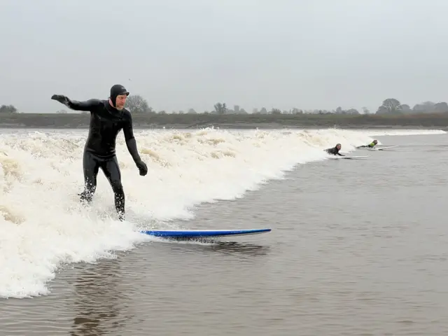 Surfers riding the bore