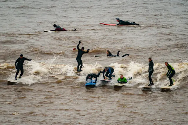 Surfers on the Severn Bore