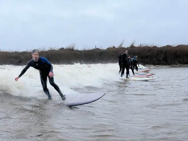 Surfers on the bore