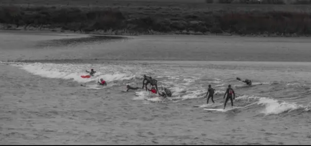 Surfers on the Severn Bore