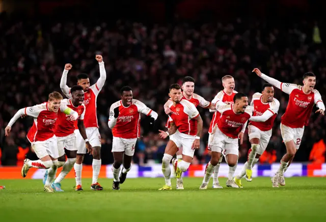 Arsenal players run to celebrate after winning the penalty shootout.