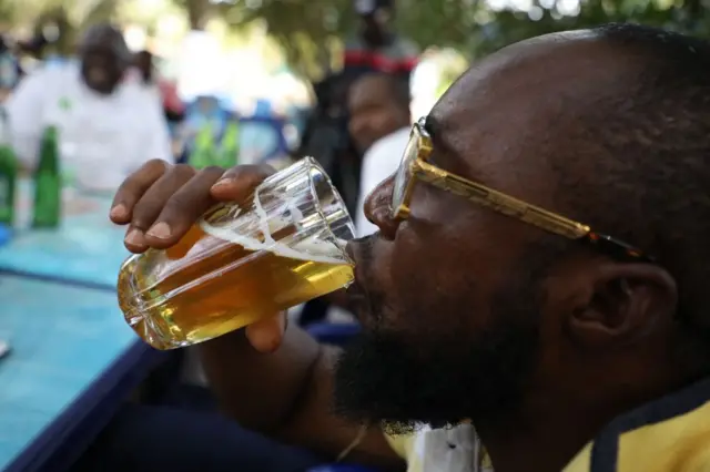 Man drinking beer in Nigeria
