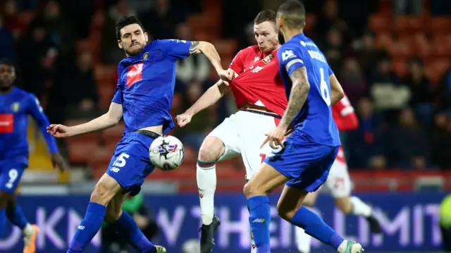 Wrexham's Paul Mullin shoots for goal