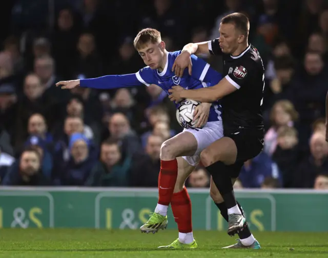 Paddy Lane of Portsmouth is tackled by Burton's Tom Hamer