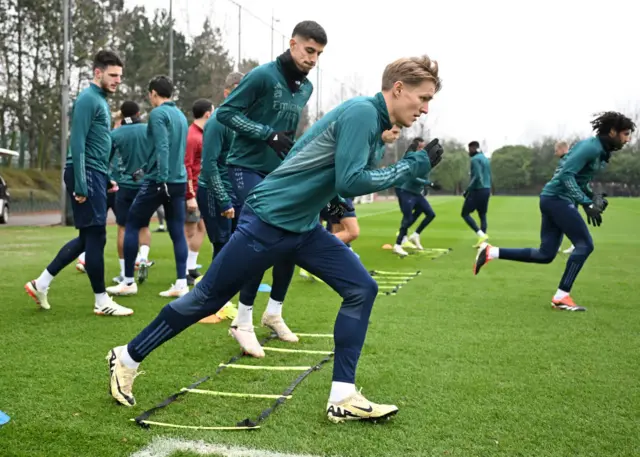 Arsebal players do a running drill in training.