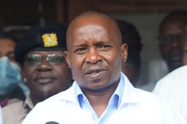 Kenya's Interior Cabinet Secretary Kithure Kindiki delivers remarks to journalists before the start of postmortem analysis on victims of the Shakahola massacre at the Malindi district funeral home, in Malindi on May 1, 2023.