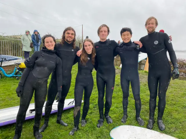 Surfers after riding the bore