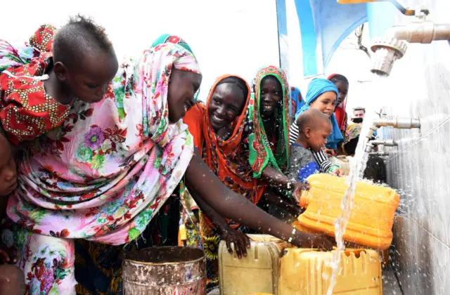 Chadian people gather around clean water in N'Djamena, Chad on July 23, 2021