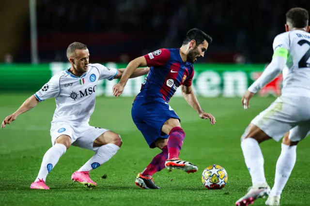 Gundogan dribbles through a crowd.