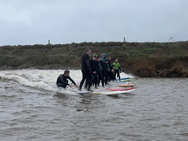 Surfers on the bore