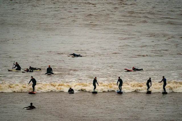 Surfers on the bore