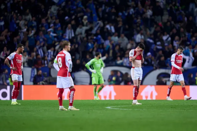 Arsenal players stand stunned after Porto's late winner.