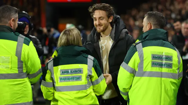 Tom Lockyer speaks to medical staff at Bournemouth