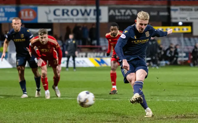 Luke McCowan scores a penalty for Dundee against Aberdeen