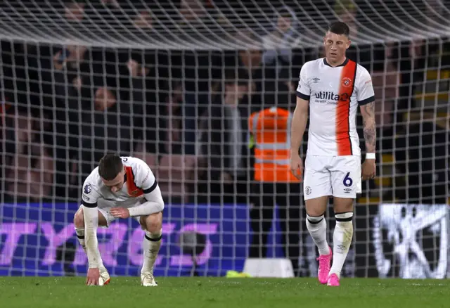 Luton players commiserate afetr Bournemouth's fourth.