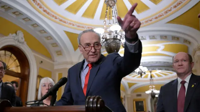 US Senate Majority Leader Chuck Schumer points to a reporter