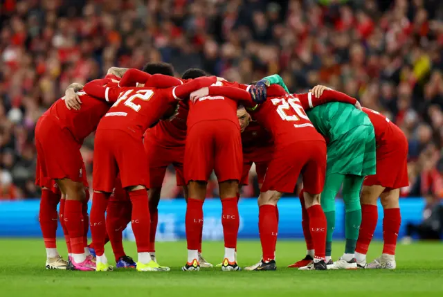 Liverpool players gather together before kick off