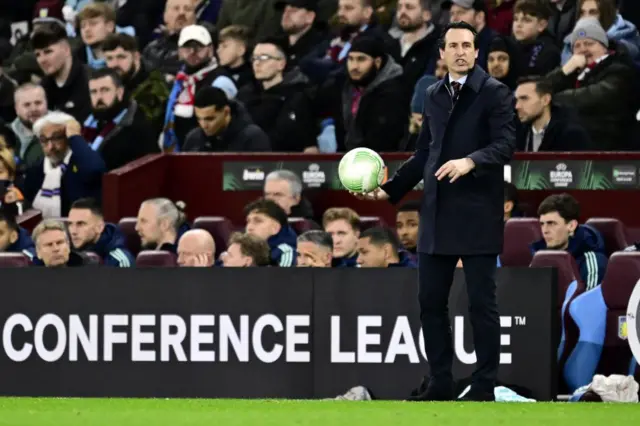 Emery stands on the touchline with the ball