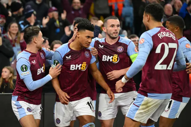 Watkins is mobbed by teammates after his goal