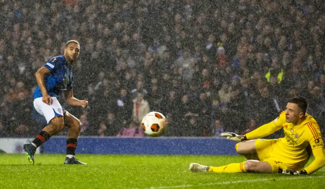 Rangers' Cyriel Dessers see's his shot saved by Benfica's Anatoliy Trubin during a UEFA Europa League Round of 16 second leg match between Rangers and Benfica at Ibrox Stadium