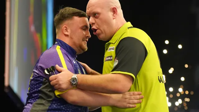 Luke Littler hugs Michael van Gerwen