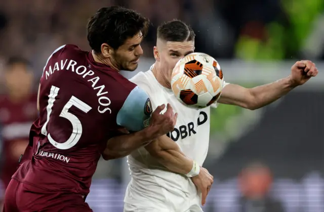 Mavropanos and Sallai duel for the ball.