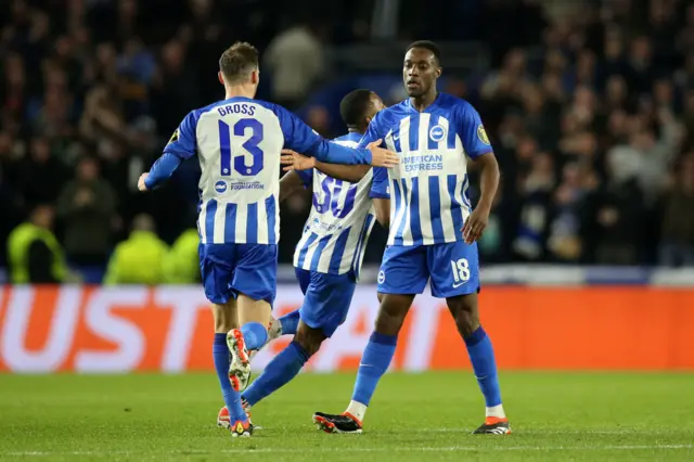 Birghton players high five welbeck on their way back to ko.