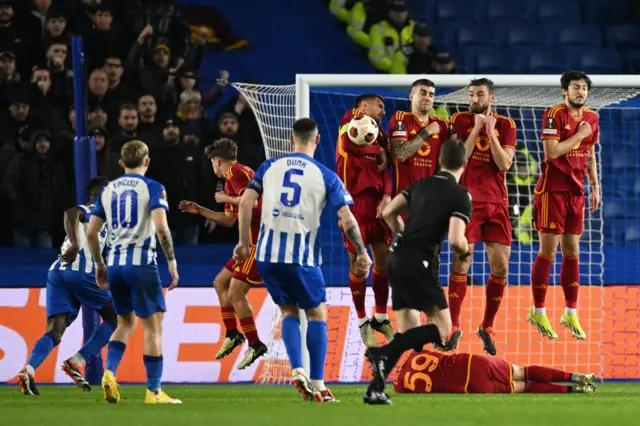 Dunk smacks a free kick into the wall.