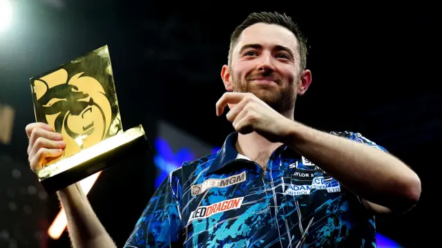 Luke Humphries with trophy after winning night six of Premier League Darts in Brighton