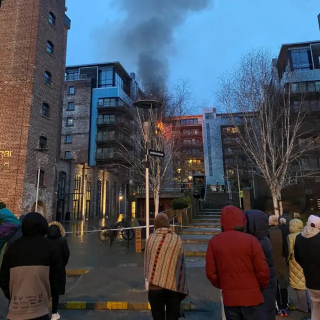 Residents in Leith look on