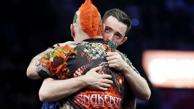 Luke Humphries hugs Peter Wright