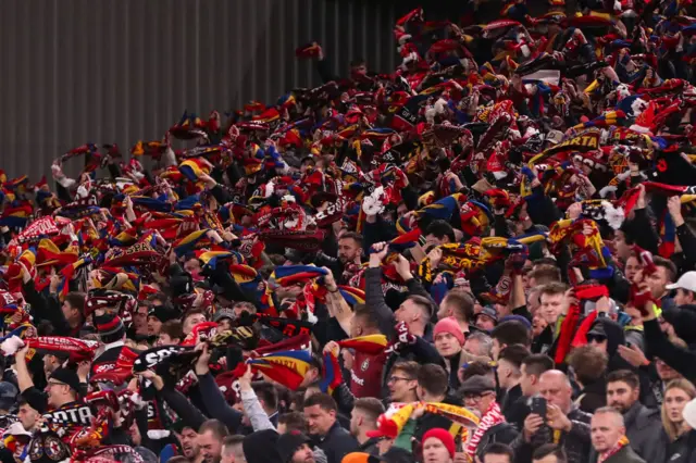 Sparta fans wave scarves in support of their side.