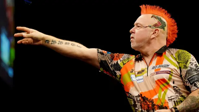 Peter Wright throws a dart