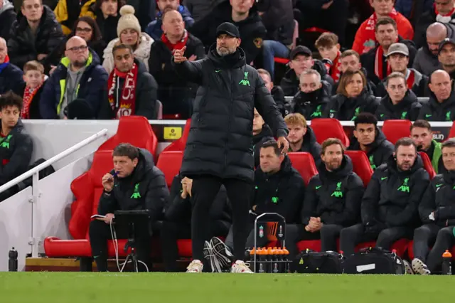 Klopp gestures from infront fo the Liverpool bench