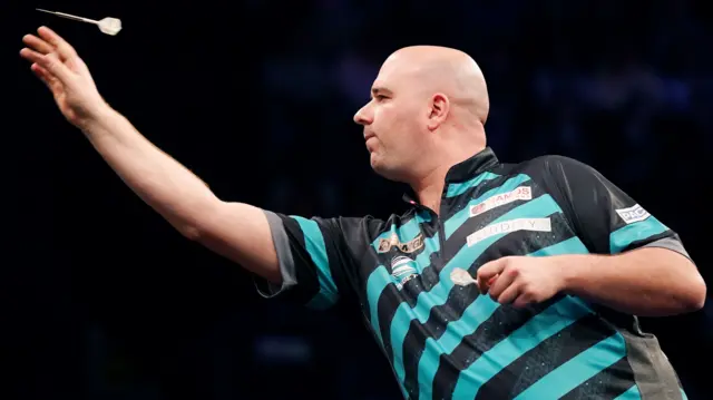 Rob Cross throws a dart