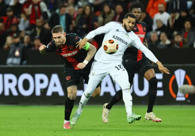 Leverkusen players close down a Qarabag player in midfield