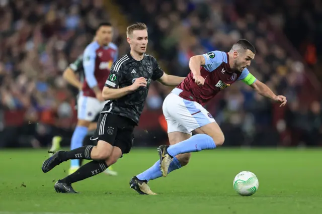 McGinn breaks through several challenges in midfield.