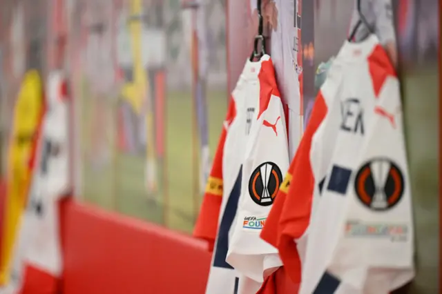 Slavia Prague shirts hang ready in their dressing room.