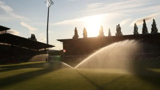 Sprinkler and sunshine over the Racecourse Ground in Wrexham