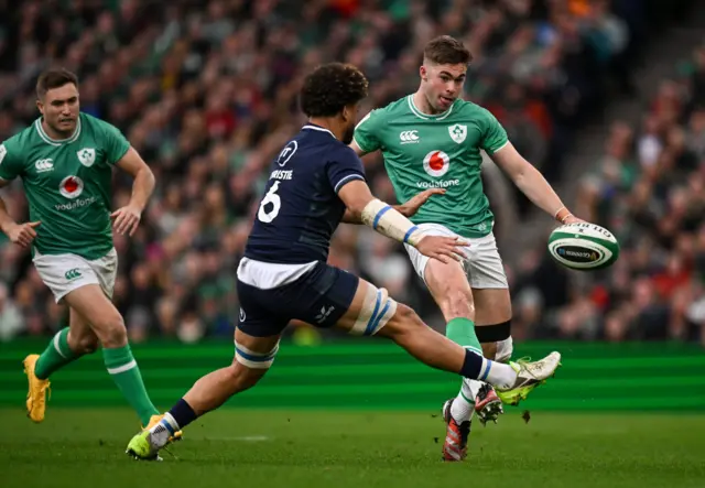 Jack Crowley of Ireland kicks past Andy Christie